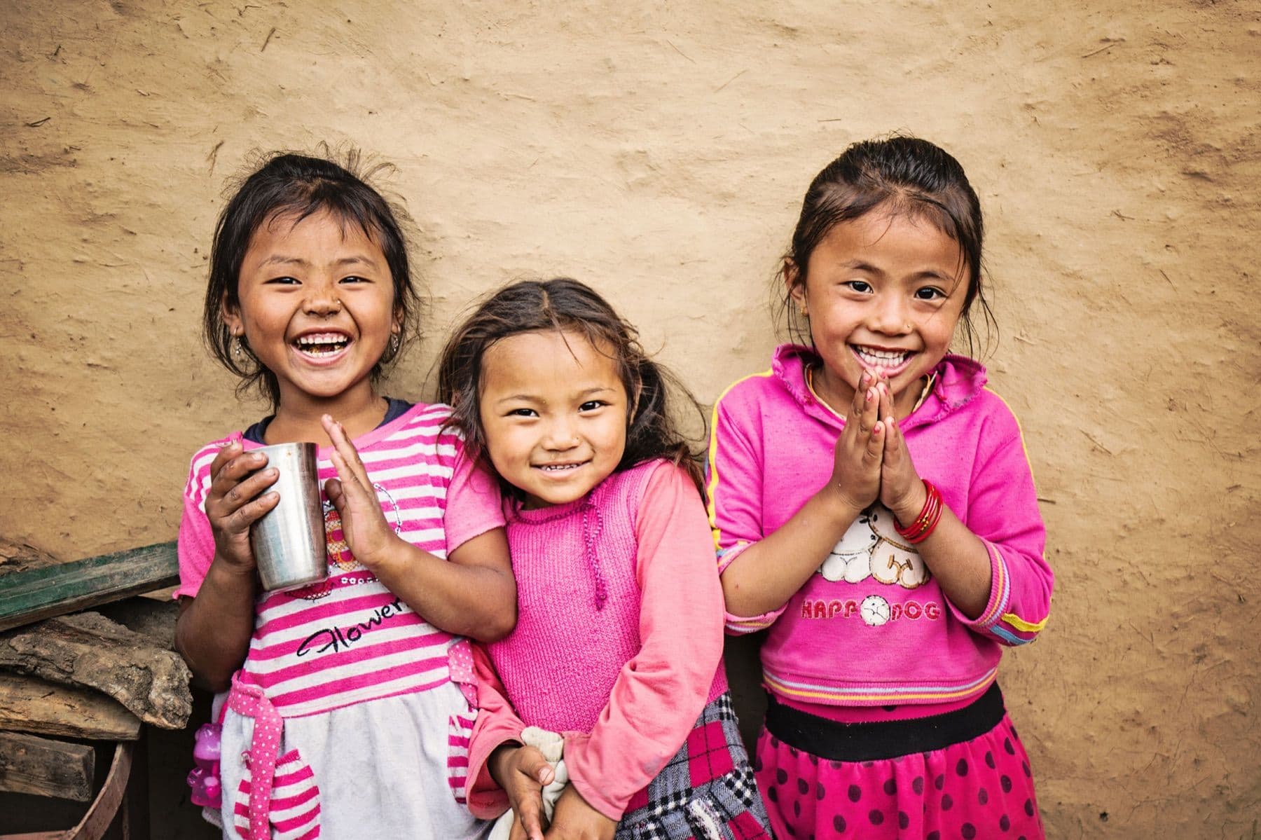 Three girls smiling together in Nepal.
