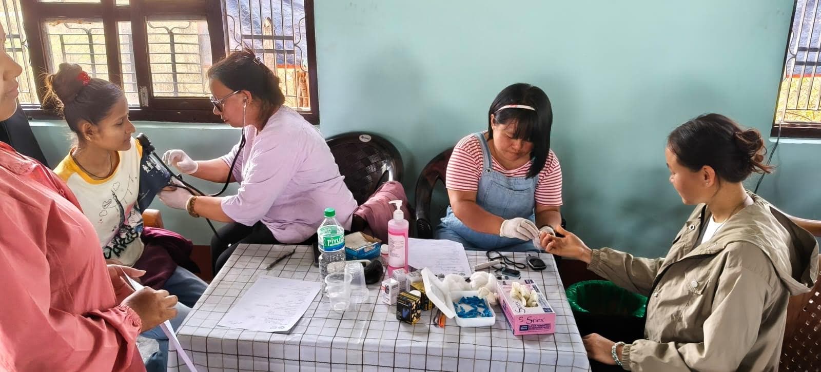 Health workers checking patients and recording information during the Madi camp.
